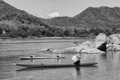 People in boats in river