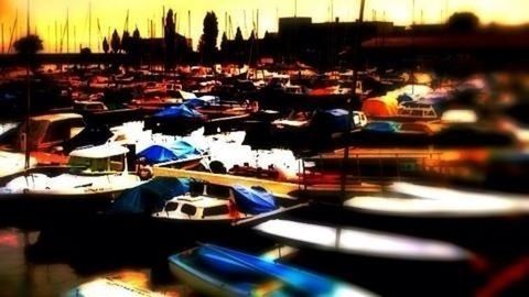 transportation, mode of transport, land vehicle, car, nautical vessel, moored, sunset, boat, reflection, stationary, selective focus, water, in a row, travel, parking, parking lot, no people, sky, street, outdoors