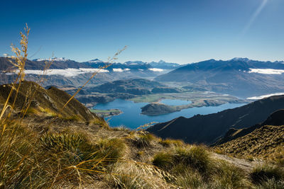 Scenic view of mountains against clear blue sky