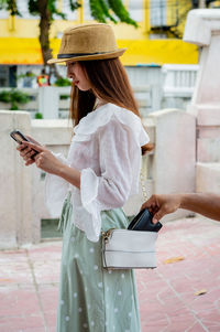 Midsection of woman using mobile phone