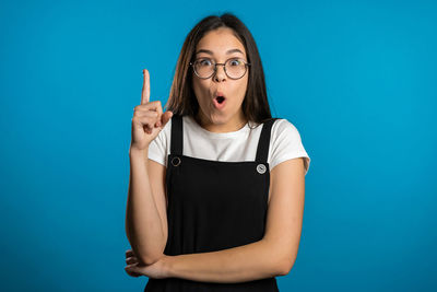 Portrait of a beautiful young woman over blue background