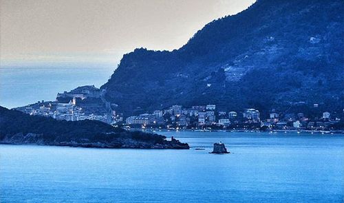 Scenic view of sea with cityscape in background