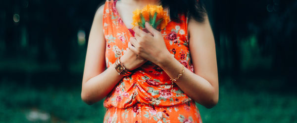 Midsection of woman standing against blurred background