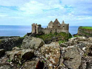 Castle by sea against sky