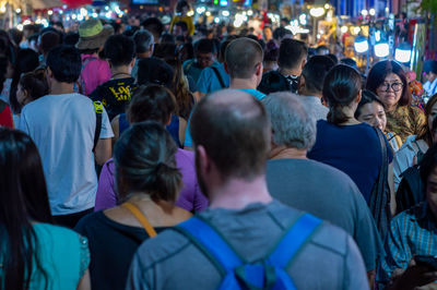 Rear view of people on street in city