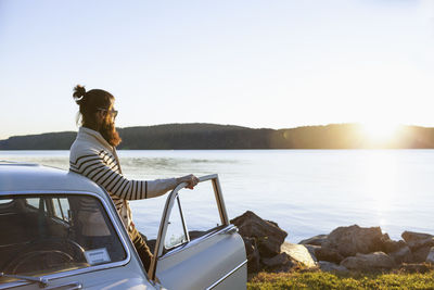 Young man admiring the view at a scenic lake