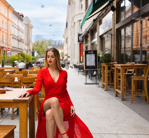 Portrait of young woman standing in city