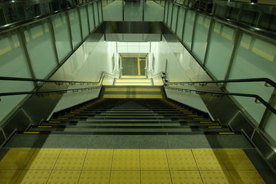 Low angle view of escalator in illuminated building