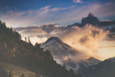 Scenic view of snowcapped mountains against sky during sunset