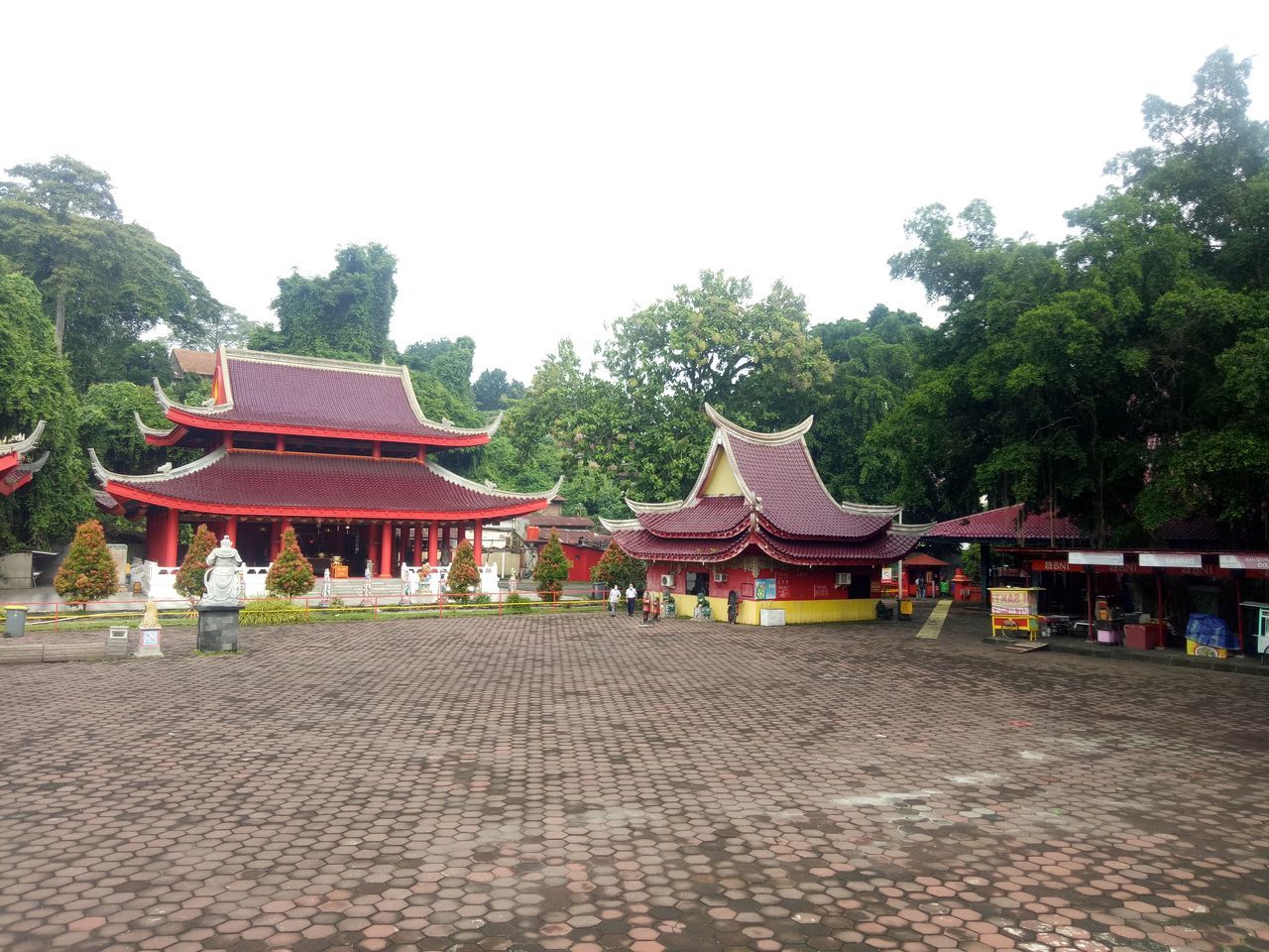 architecture, built structure, religion, tree, temple - building, belief, plant, temple, building, building exterior, travel destinations, spirituality, tradition, nature, sky, place of worship, travel, shrine, tourism, roof, history, the past, city, chinese architecture, outdoors, pagoda, no people, ancient, day, red, clear sky