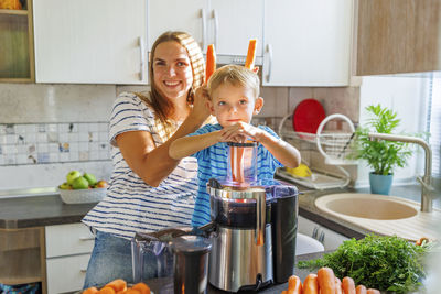 Portrait of smiling family sitting at home