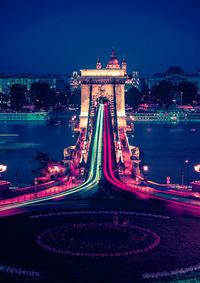 Illuminated bridge in city at night