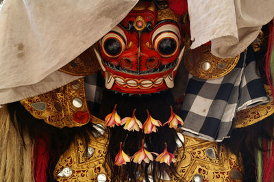 Close-up of traditional mask hanging against wall