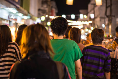 Rear view of people at night