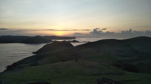 Scenic view of silhouette mountains against sky during sunset