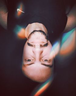 Upside down portrait of man with lens flare