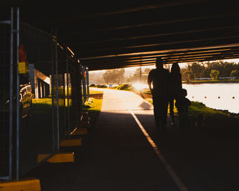 Rear view of people walking on railroad station platform