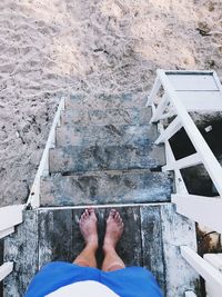 Low section of person standing on staircase