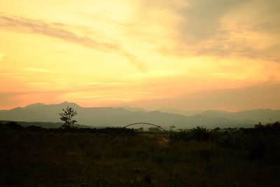 Scenic view of mountains against sky at sunset