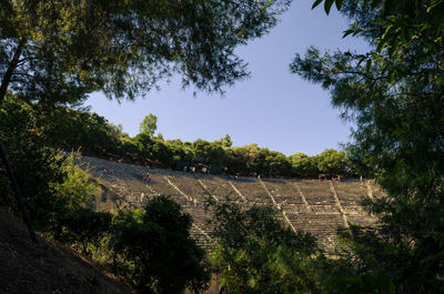 High angle view of road amidst trees against sky