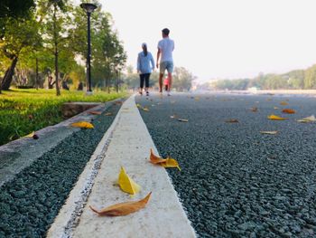Rear view of men walking on street