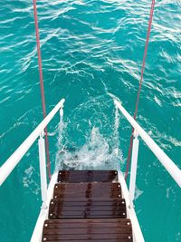 High angle view of ladder by swimming pool