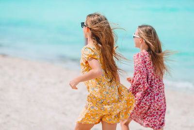Sisters running on beach