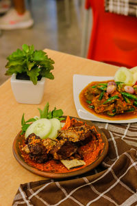 High angle view of food served on table grilled ribs iga bakar saute beef skin green chili