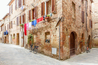 Italian alleyway with hanging laundry and parked bicycles