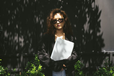 Portrait of young woman standing outdoors