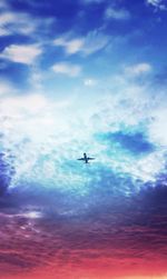 Low angle view of silhouette airplane flying in sky