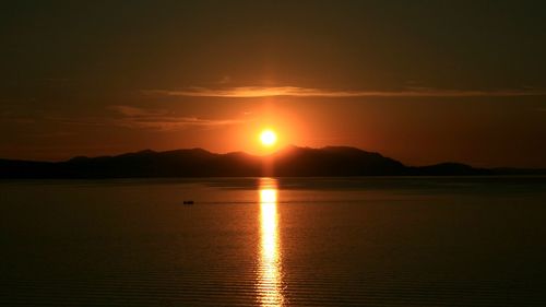 Scenic view of lake against sky during sunset