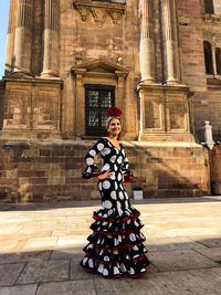 Full length of woman standing outside building