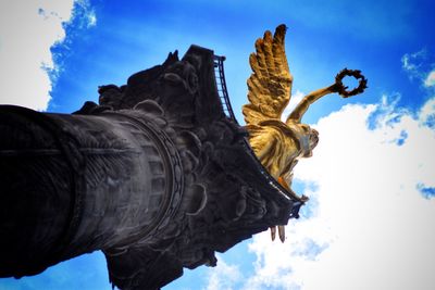 Low angle view of statue against cloudy sky