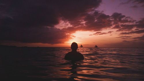 Silhouette of sea against sky during sunset