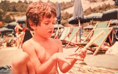 Portrait of shirtless boy looking at camera