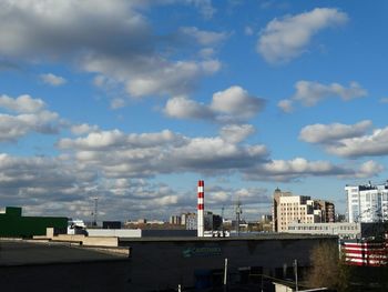 Buildings against cloudy sky