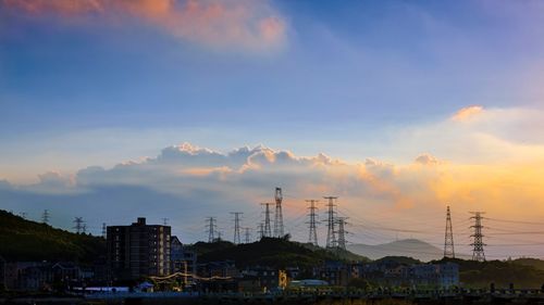 Electricity pylon against sky during sunset