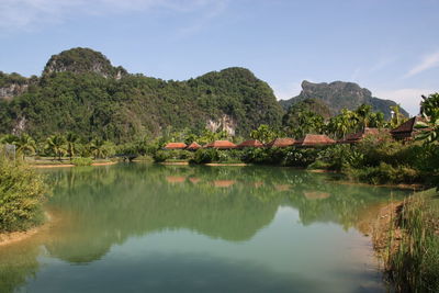 Scenic view of lake by trees against sky