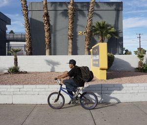 Man riding bicycle on street in city