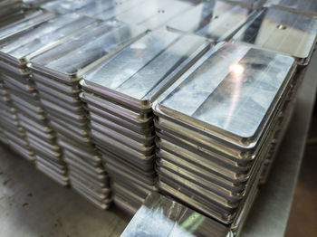 Stacks of shiny metal tiles after cnc surface milling