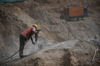 Low angle view of man working at construction site