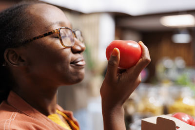 Side view of young man holding heart