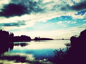 Scenic view of lake against cloudy sky