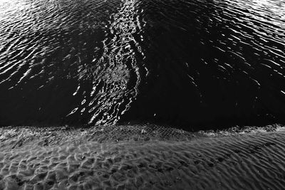 High angle view of sea waves on beach