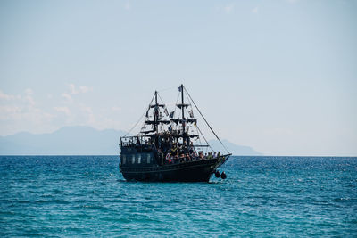 Sailboat sailing on sea against clear sky