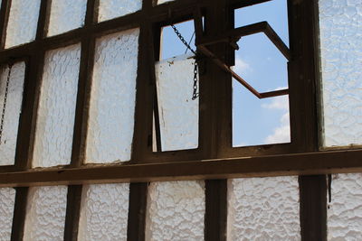 Low angle view of window in abandoned building