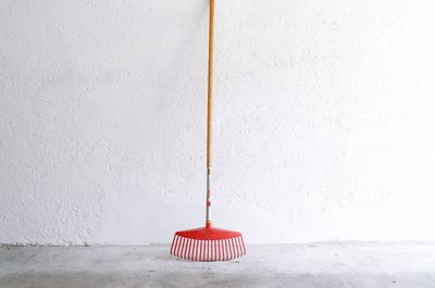 Close-up of red umbrella hanging on wall