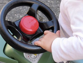 Close-up of cropped hand holding camera