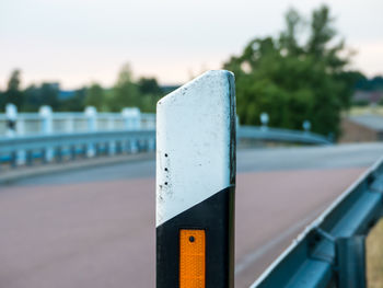 Close-up of metallic railing against sky